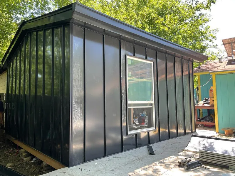 Black standing seam metal wall panels for Roof Inspection in Plano