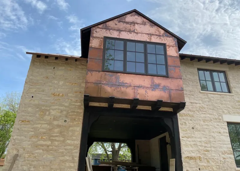 Copper metal panel facade on a stone building for Skylight Installation in Plano